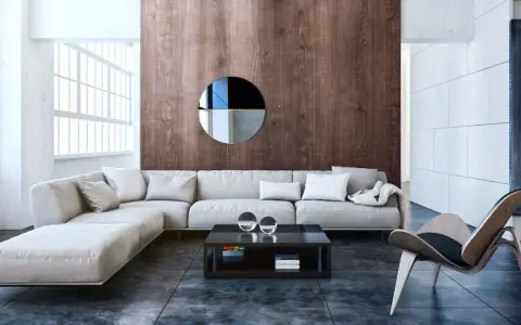 Nowoczesny salon w stylu bauhaus z szarą sofą, drewnianą ścianą i designerskim fotelem.