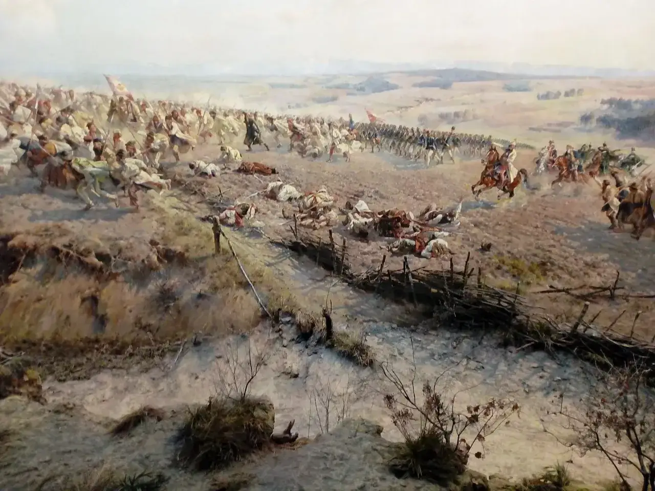 Bitwa na obrazie polskiego malarza Jana. Widać szarżę kawalerii, piechotę i poległych żołnierzy.